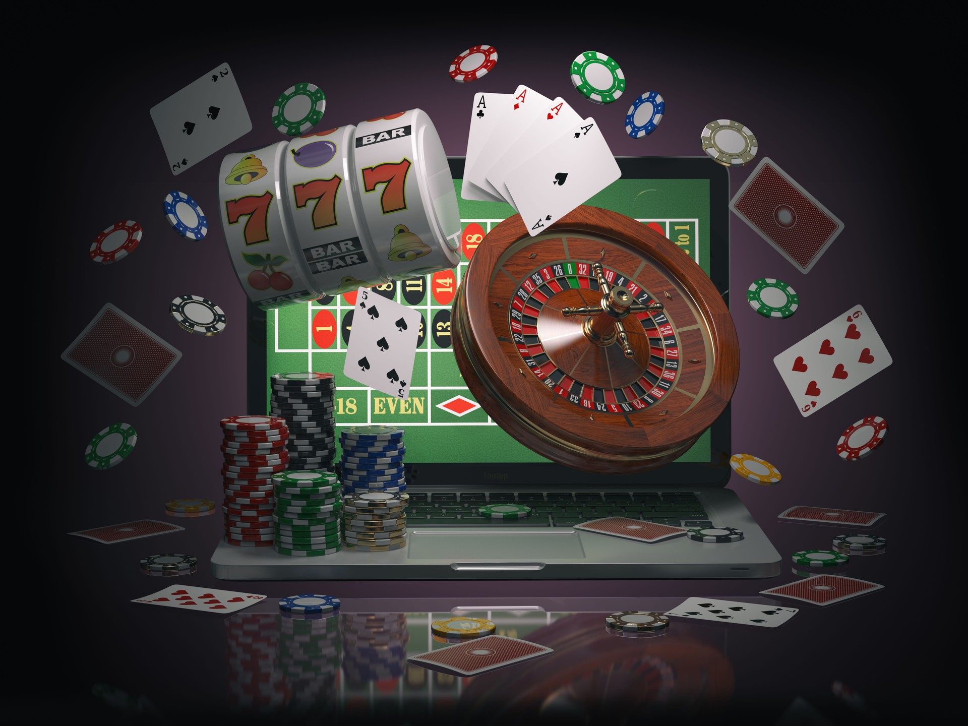 Online casino concept. Laptop roulette, slot machine, chips and  cards