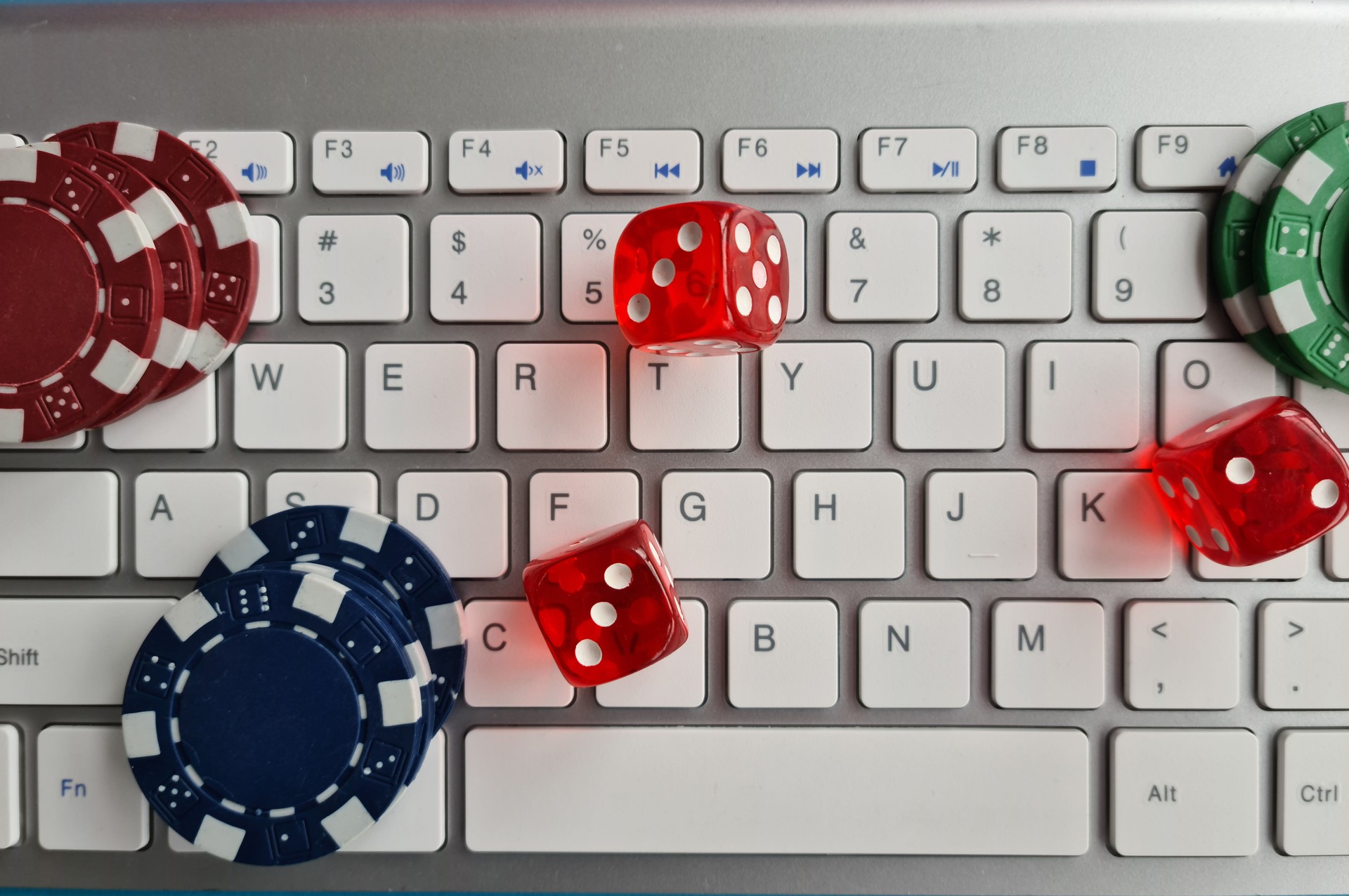 Cool casino chips and dice on laptop computer keyboard